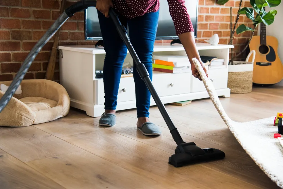 Vacuuming and cleaning living room floors